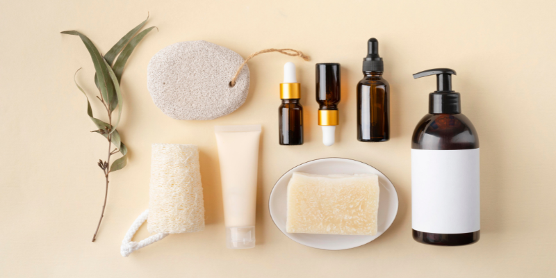 Bird's eye view of a spa kit, including lotion, serums, soap, and sponges.