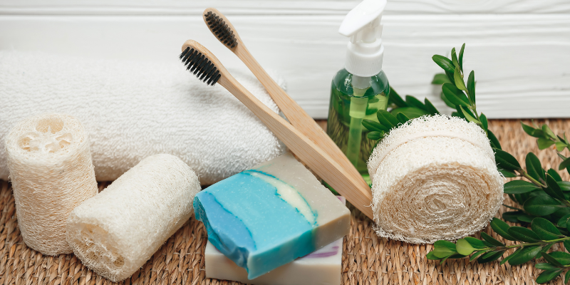 Wooden bamboo toothbrush with soap and sponges.