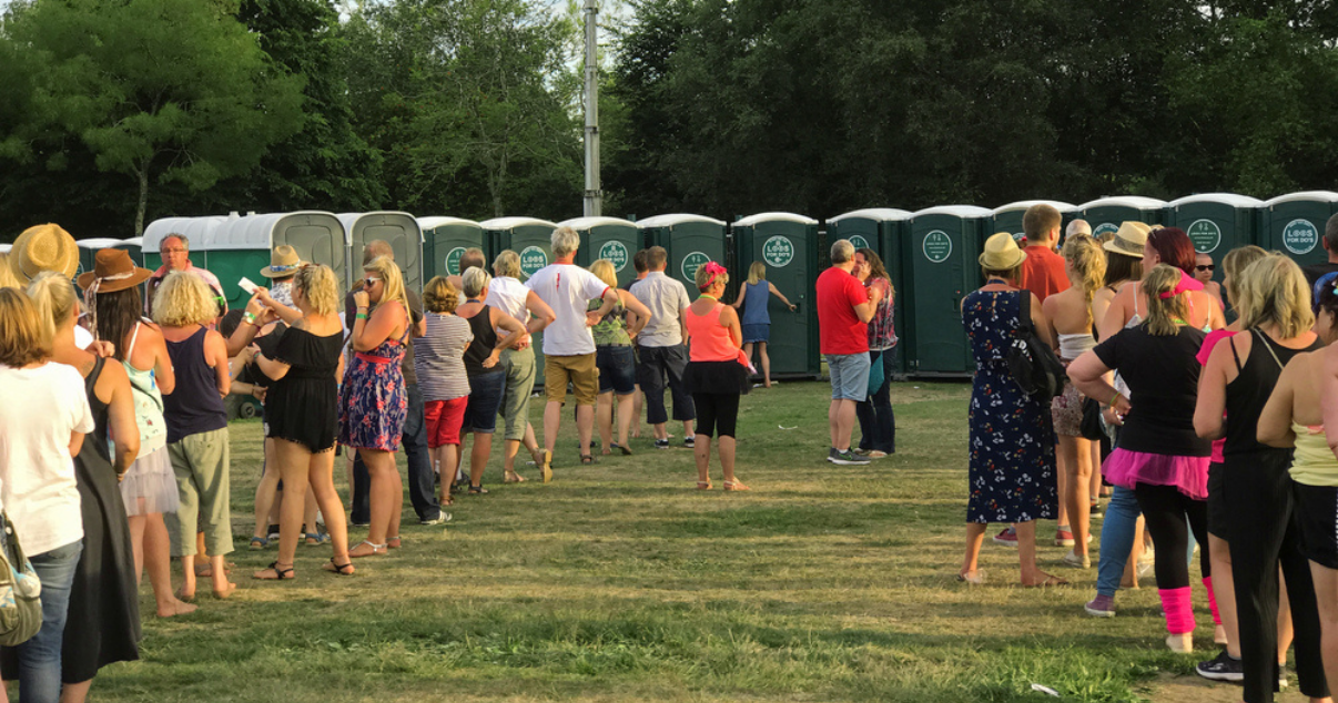 People waiting in line to get to the toilet at a music festival