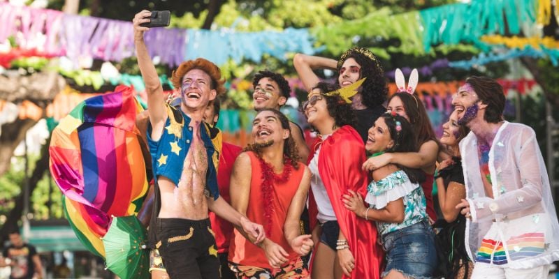 Smiling group of friends taking a selfie at a lively festival