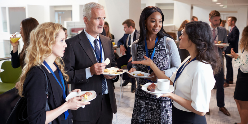 4 people facing each other while speaking at a conference event.