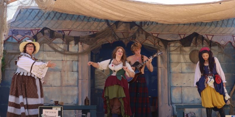 renaissance performers on stage at a renaissance fair