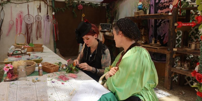 artisans making crafts at a renaissance fair