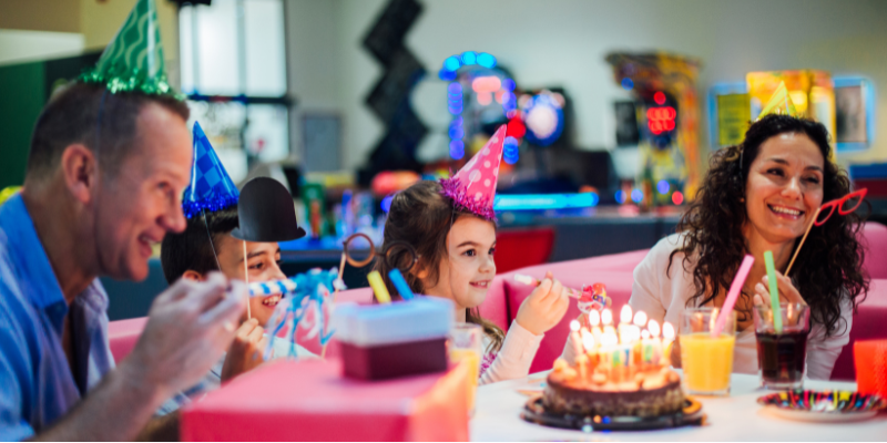 Family celebrating birthday in bowling alley