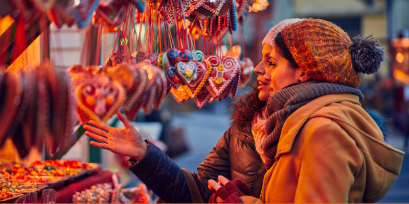 Friends buying candies at a Christmas market