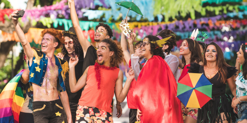 Happy young people wearing colorful outfits at a carnival in Brazil