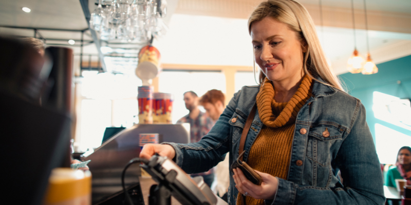 Woman paying for concessions with credit card machine