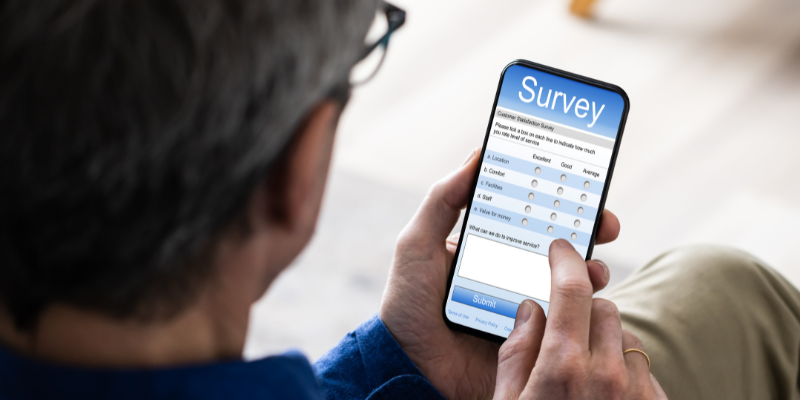 Man answering survey questions on a mobile phone
