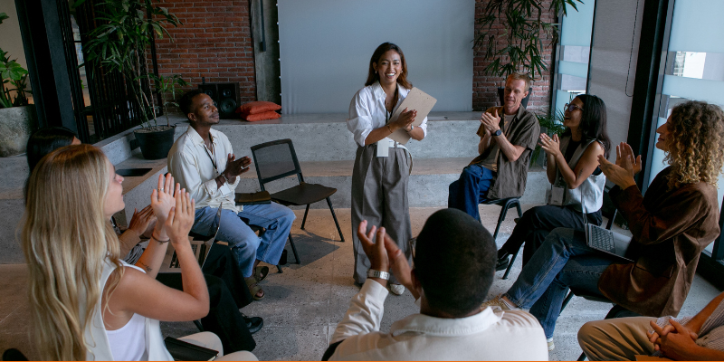 People clapping during a roundtable discussion in a workshop