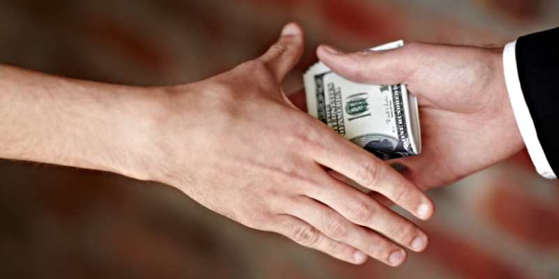 Cropped hands receiving an illegal payout