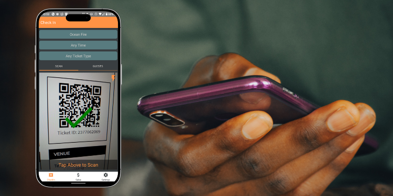 Close-up view of a person holding a mobile phone with one hand, in the foreground is a mockup of the Passage Manager app successfully scanning a QR code ticket