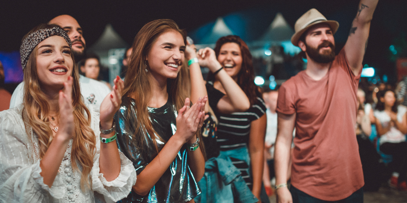 Friends enjoying summer music festival at night