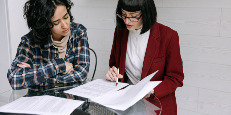 Two women reviewing a contract together