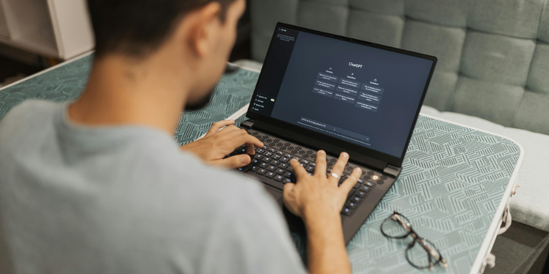 Man using laptop computer to use ChatGPT