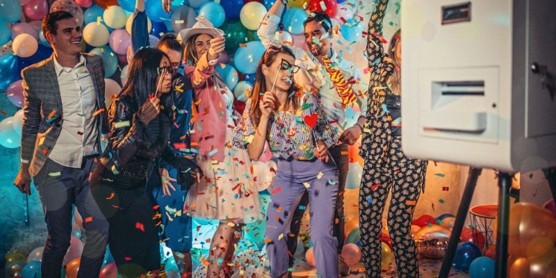 group of people holding props and posing for a photo