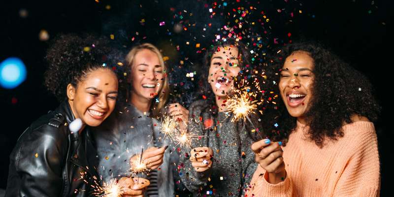 happy people playing with sparklers