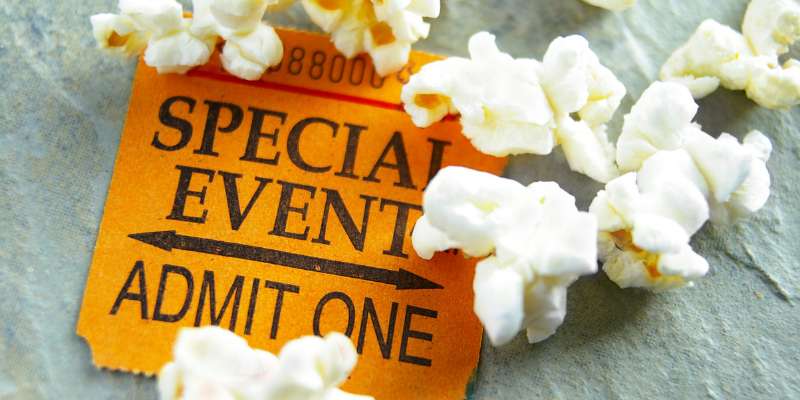 special event admit one ticket with popcorn spilled around it