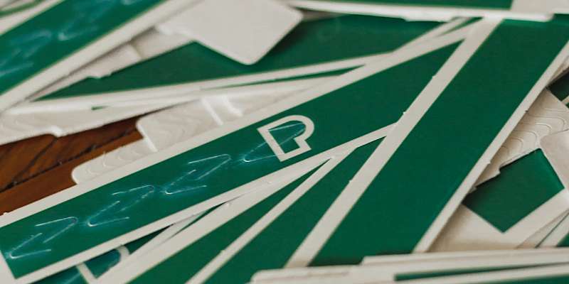 messy pile of unused green paper wristbands