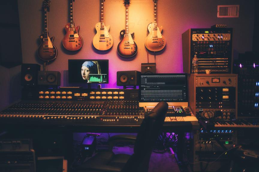 recording studio with guitars hanging on the wall