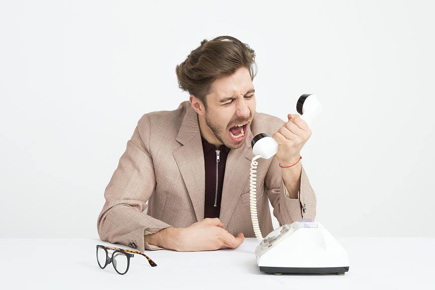 angry man yelling into telephone