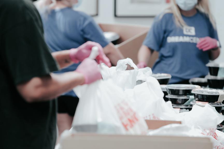 volunteers packing bags and boxes of food