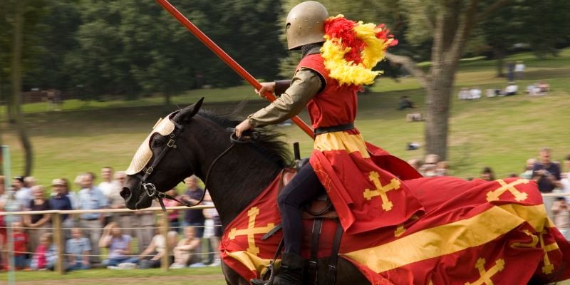 knight jousting on horseback at a renaissance fair