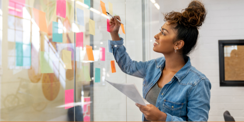 Creative businesswoman brainstorming at the office using post-its