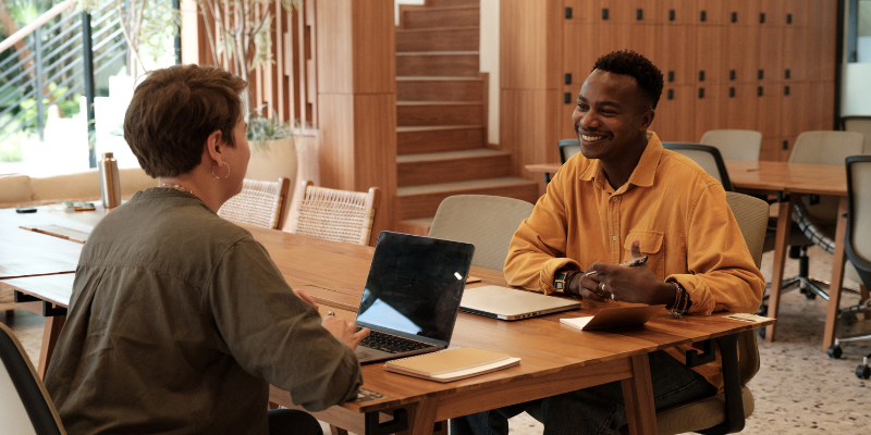 Office HR environment with two workers chatting with each other 