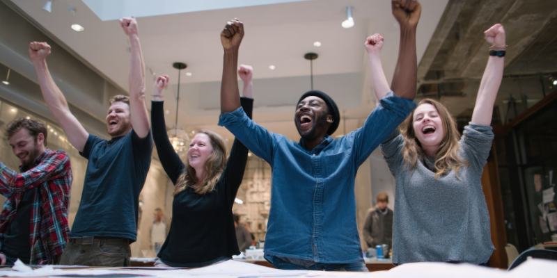 Diverse group of people celebrating in a casual office