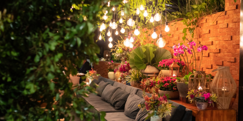 Beautiful venue with comfy couches decorated with flowers, greenery and lights